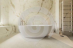 Detail of a bathroom with marble walls, a continuous worktop in the