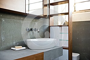 Detail of bathroom in rough concrete grey style