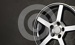 detail of beautiful black with polished front surface alloy wheel , spare parts for car copy space