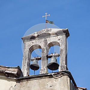 Detail of the bell tower of an ancient Catholic church