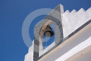 Detail of the bell tower of a hermitage with a bell