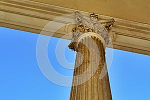 detail from below of ancient marble colonnade in neoclassical style