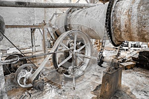 Detail of belt powered machine in factory for grinding limestone