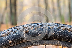 Detail of a bicycle tire. Mountain bike tire in the mud. Mud sticks to a bicycle wheel after cycling