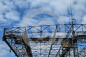 A detail of a big old crane in a dockyard.