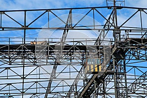 A detail of a big old crane in a dockyard.