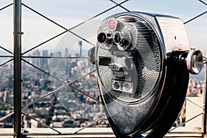 Detail of binoculars and background view of New York City from the Empire State Building. USA America, Manhattan