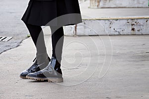 Detail of black booties on the street