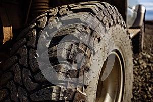 Detail of a black offroad tire on a offroad truck vehicle, built for dirty offroad roads