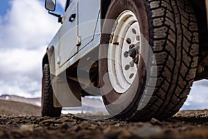 Detail of a black offroad tire on a offroad truck vehicle, built for dirty offroad roads