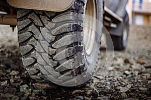 Detail of a black offroad tire on a offroad truck vehicle, built for heavy rides