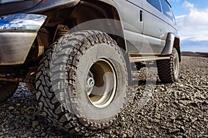 Detail of a black offroad tire on a offroad truck vehicle, built for heavy rides