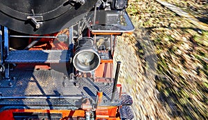 Detail of a black old steam locomotive while driving. Dynamics through motion blur