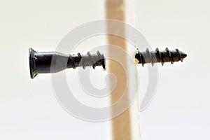 Detail of a screw going through a wall photo