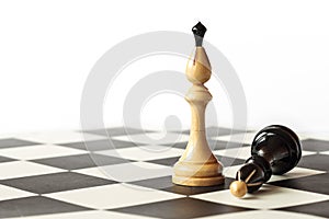 Detail of black and white kings on chessboard