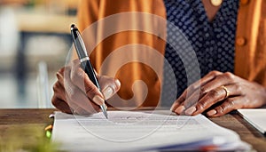 Detail of black woman hands writing on paperwork