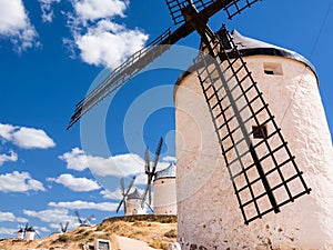 Detail of the blades of a windmill in Consuegra and other windmills in the background (spain
