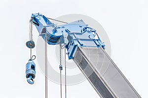 Detail of blue construction crane for heavy lift using in construction industry with white background.