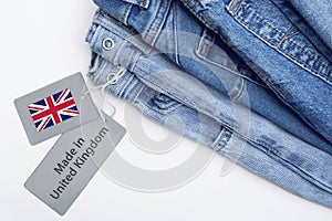 Detail of blue jeans, label and Made in United Kingdom lettering.