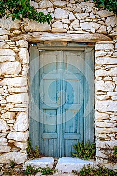 Detail of blue wooden door in vintage stone wall
