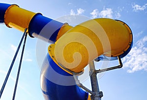 Detail of a blue and yellow water slide in an abstract style