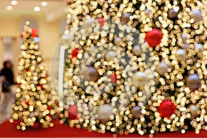Detail Blurred View of an opulent Christmas Tree Decoration in a Shopping Center during Christmas Time - Bokeh Background