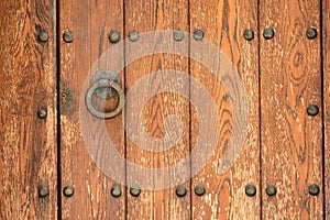 Detail of a wooden door with knocker photo