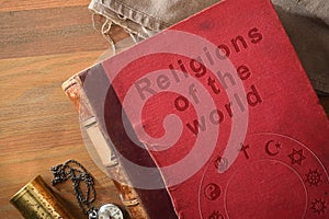 Detail of book of world religions on wooden table photo