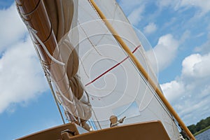Detail of boom and sail foresail, jib on a sailing boat on a sunny day, while sailing