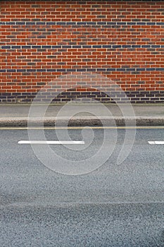 Detail of brick wall near sidewalk and street