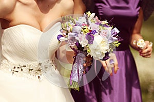 Detail and bride and bridesmaid with flowers