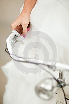 Detail of bride`s hand griping bicycle handle