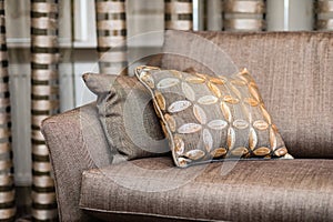 Detail of brown pillow on the brown sofa