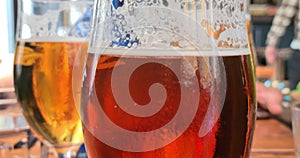 detail of bubbles of drinks red double malt beer in an english pub on