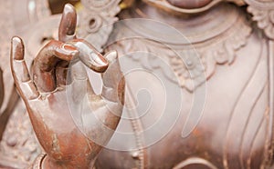 Detail of Buddha statue with Karana mudra hand position