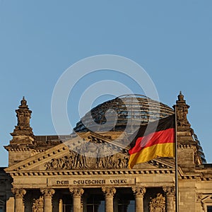 Detail of the Bundestag or Reichstag building, seat of the German Parliament, with German flag