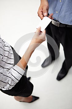 Detail businessman and woman exchanging cards