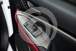 Detail on buttons controlling the windows in red car