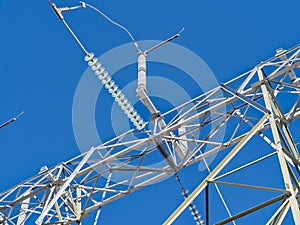 Detail of cables and insulators on the top of a high voltage transmission tower