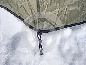 Detail of camping tent anchored in snow. Extreme winter trek