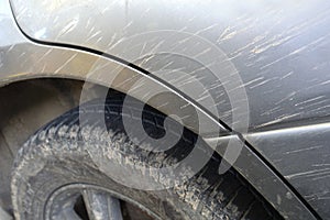 Detail of the car fender dirty by mud after a race on a muddy track