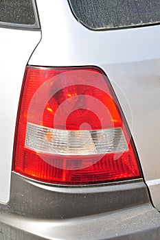 Detail of car headlights lamp, gray modern car tail red lamp
