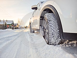 Detail of car tires in winter on the road covered with snow.