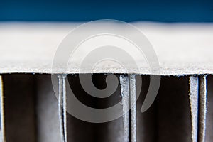 Detail of carboard packaging structure on a blue gradient background