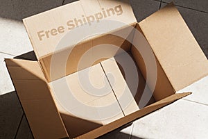 Detail of a cardboard box written on free shipping. Delivery box.