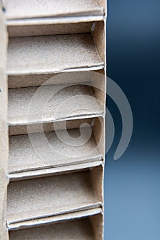 Detail of cardboard packaging structure, on a blue and black gradient background