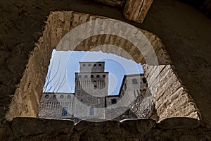 A detail of the castle of Torrechiara, Parma, Italy, framed by a stone window