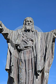 Detail of cement image of Christ with outstretched arms