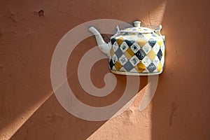 The detail of the ceramic jug walled in the wall