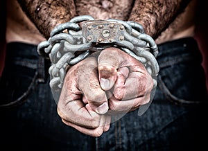 Detail of the chained hands of a man